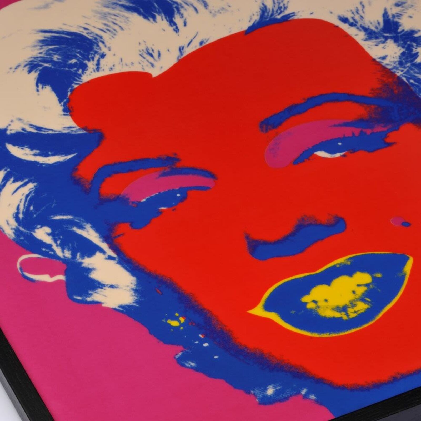 A bold pop-art portrait featuring a stylized face with vibrant red skin, blue hair, and yellow lips against a magenta background.