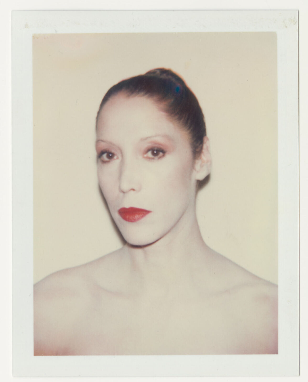 A polaroid photo of a woman with red lipstick.