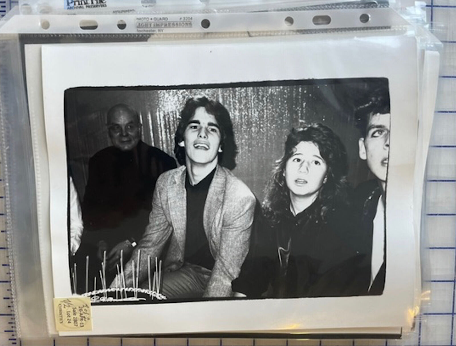 A black and white photo of a group of people posing for a picture.