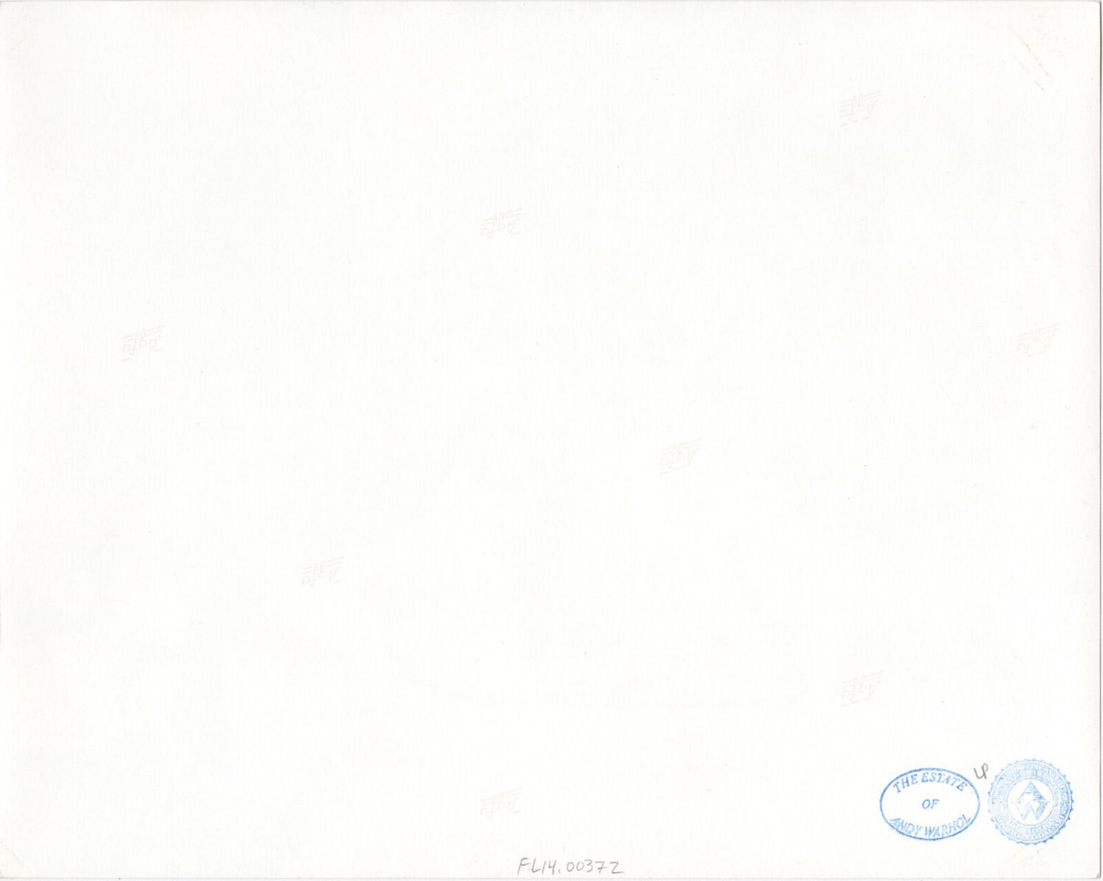 A group of people sitting around a table with a birthday cake.