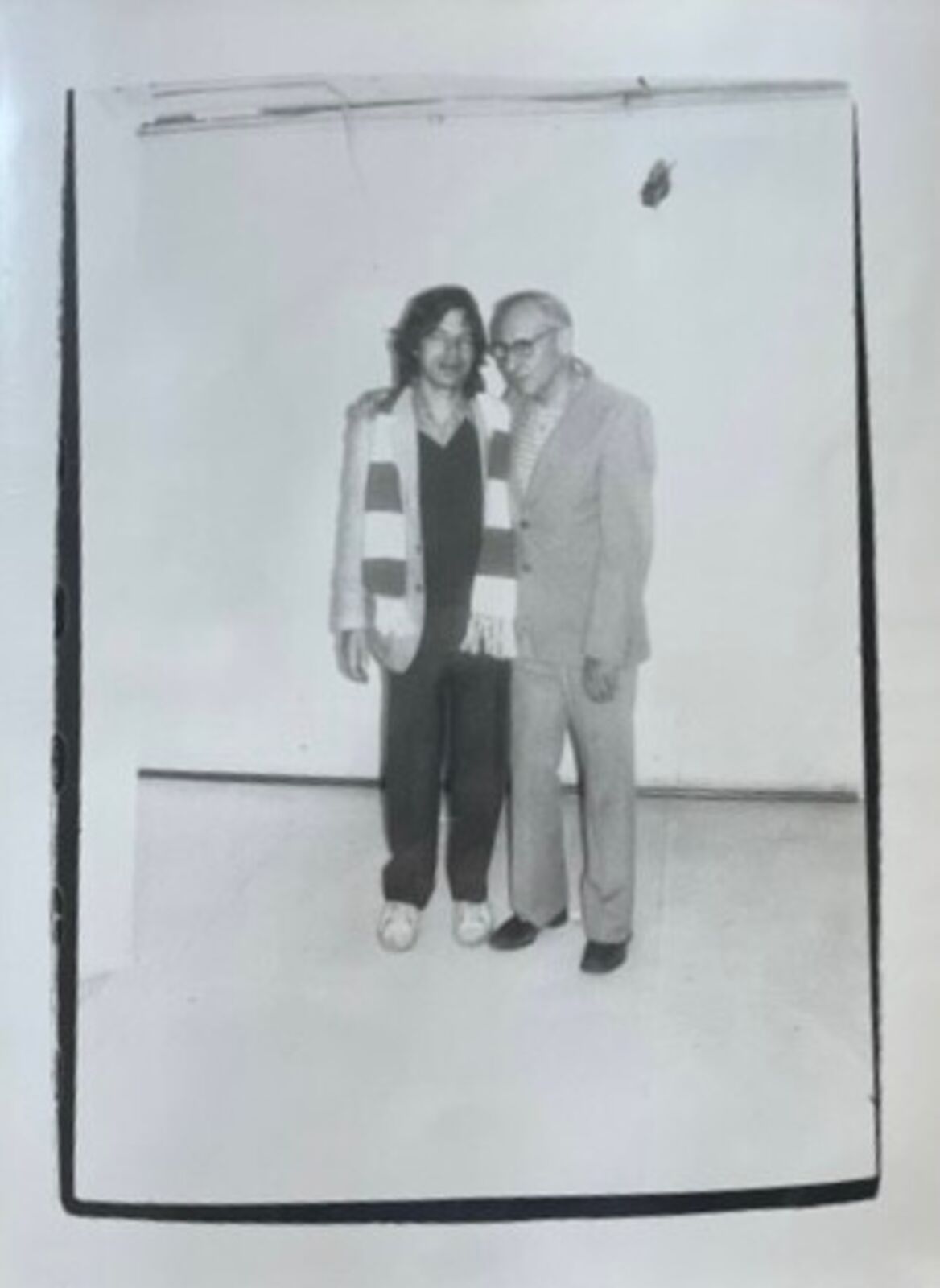 A black and white photo of a man and woman standing next to each other.