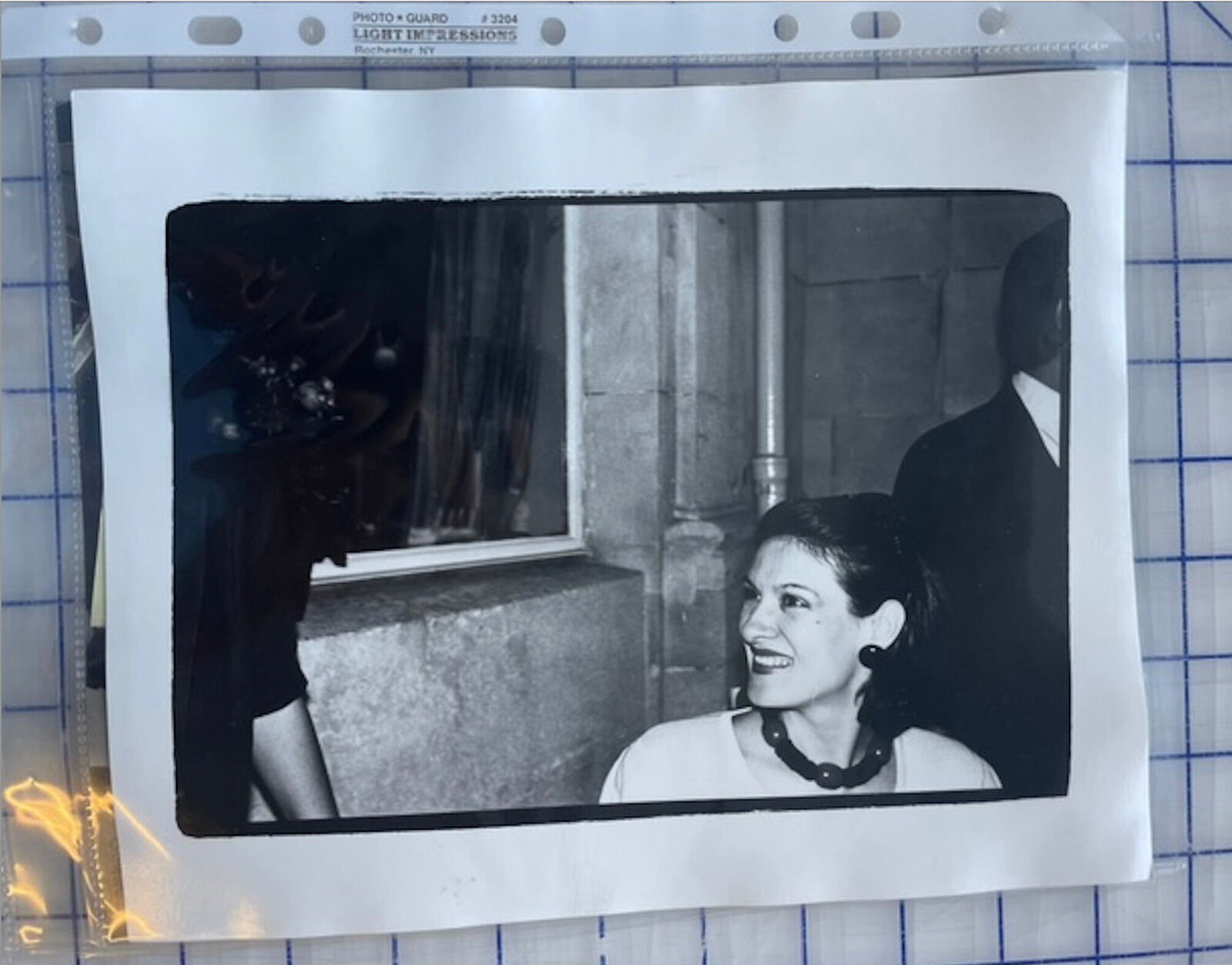 A black and white photo of a woman smiling at a man.