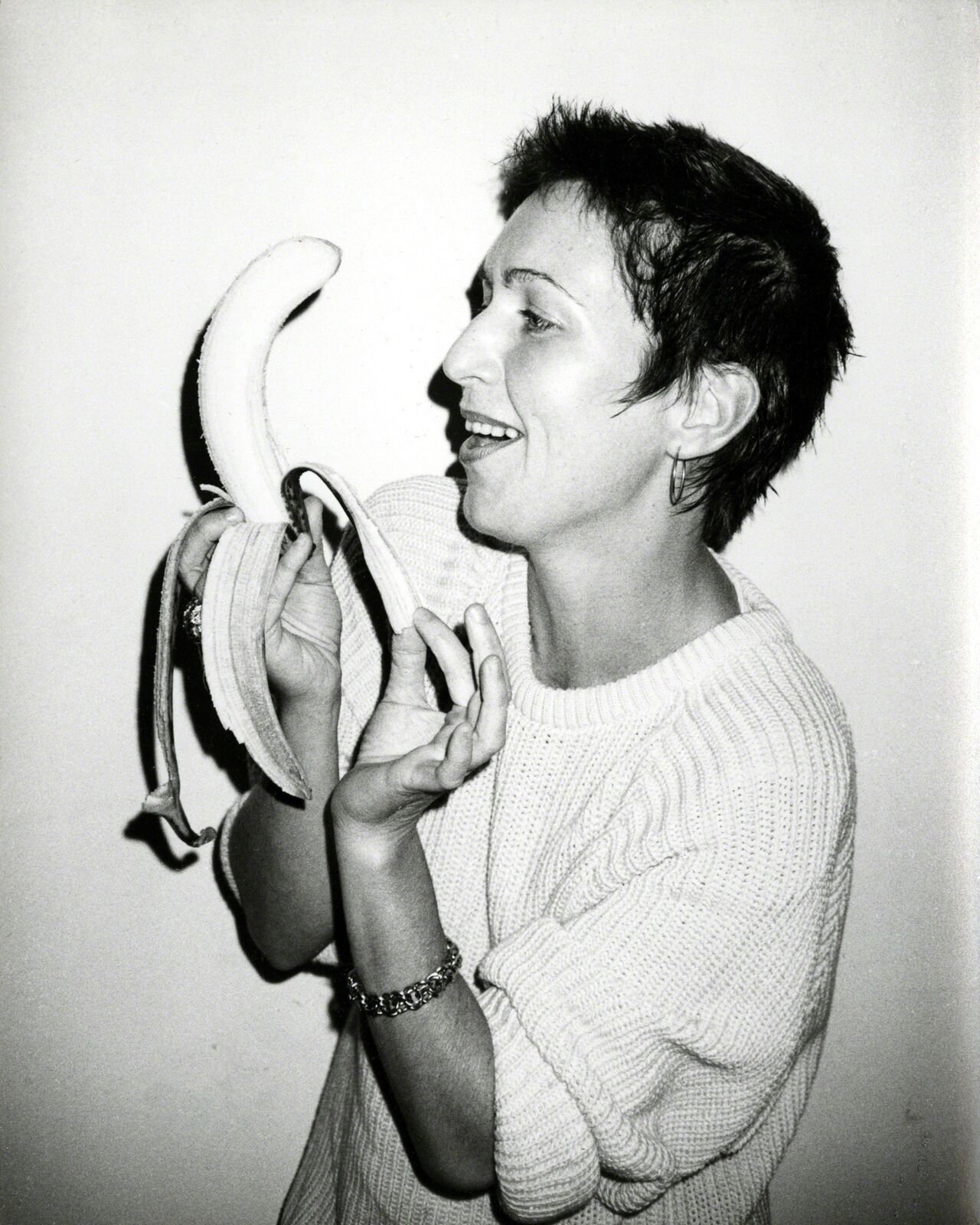 A woman holding a banana in her hands. 