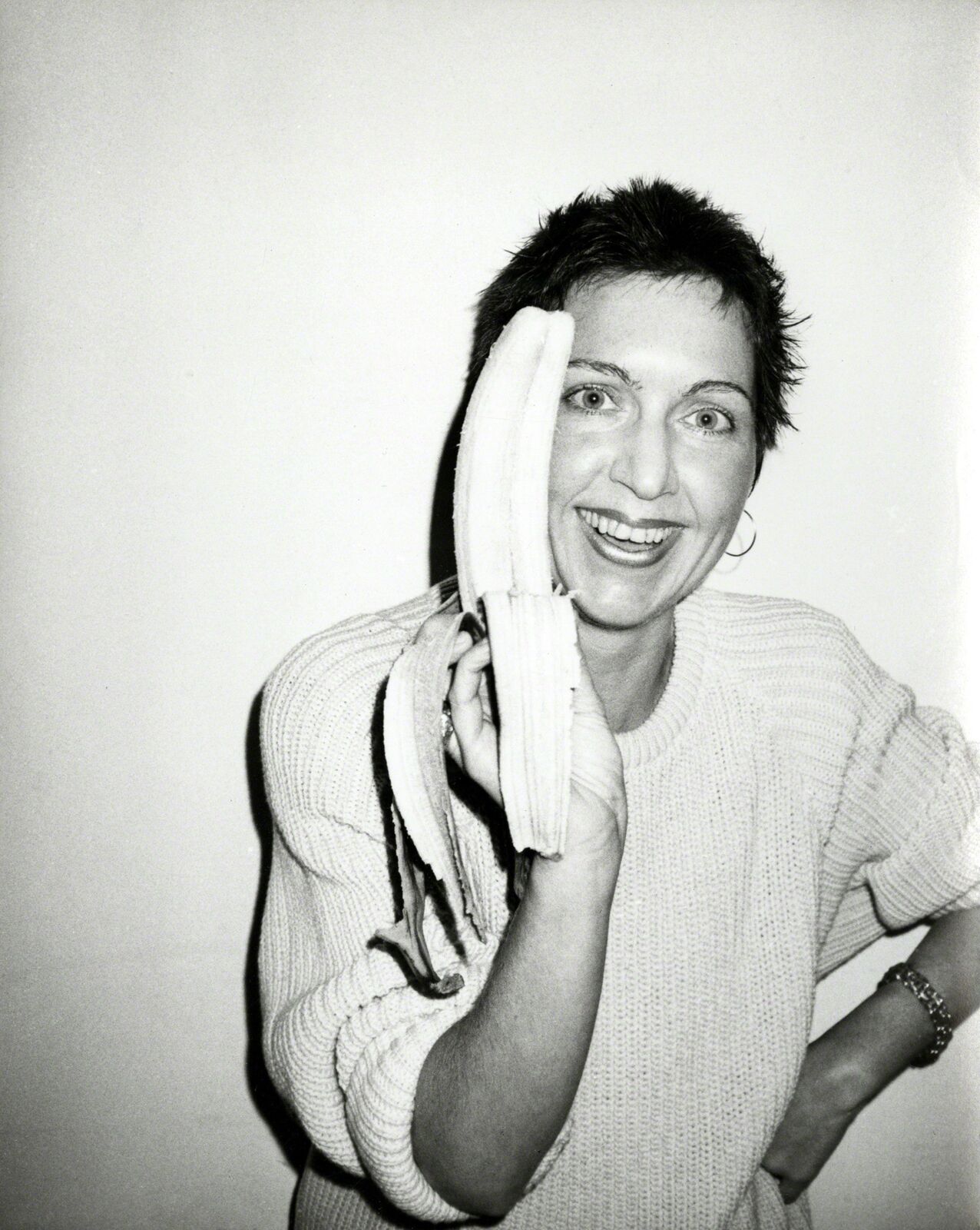 A woman holding a bunch of bananas in her hands.