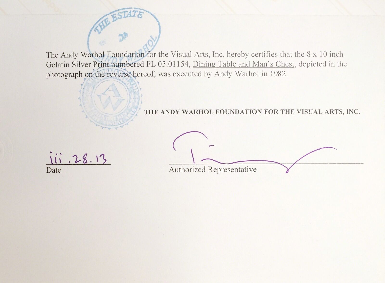 A black and white photo of a man sitting at a table.