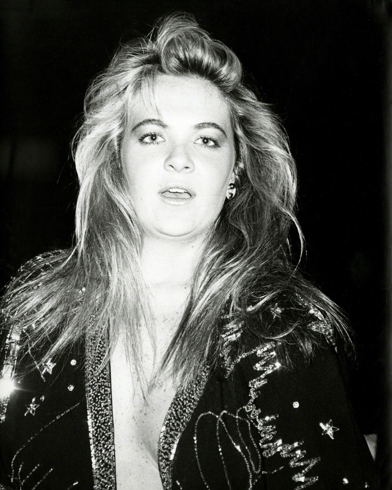 A black and white photo of a woman with long hair.