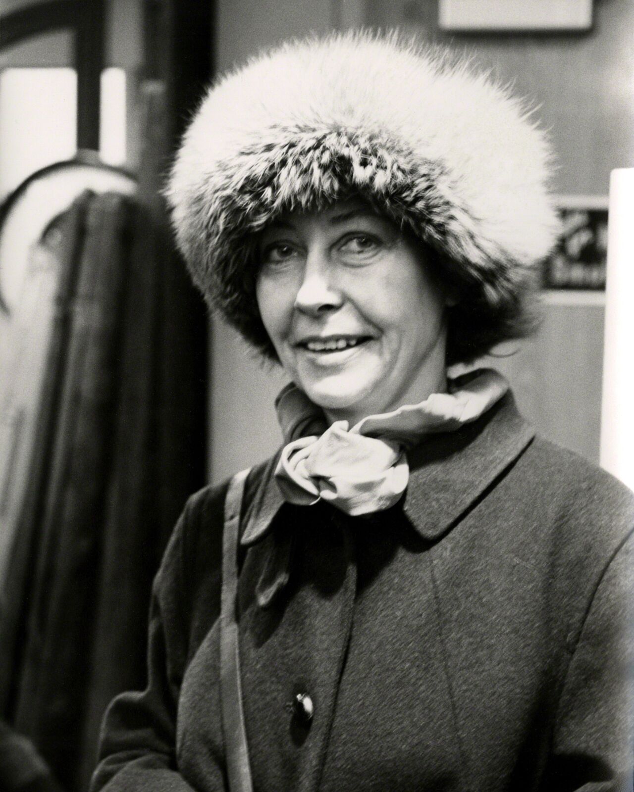 A black and white photo of a woman wearing a fur hat.