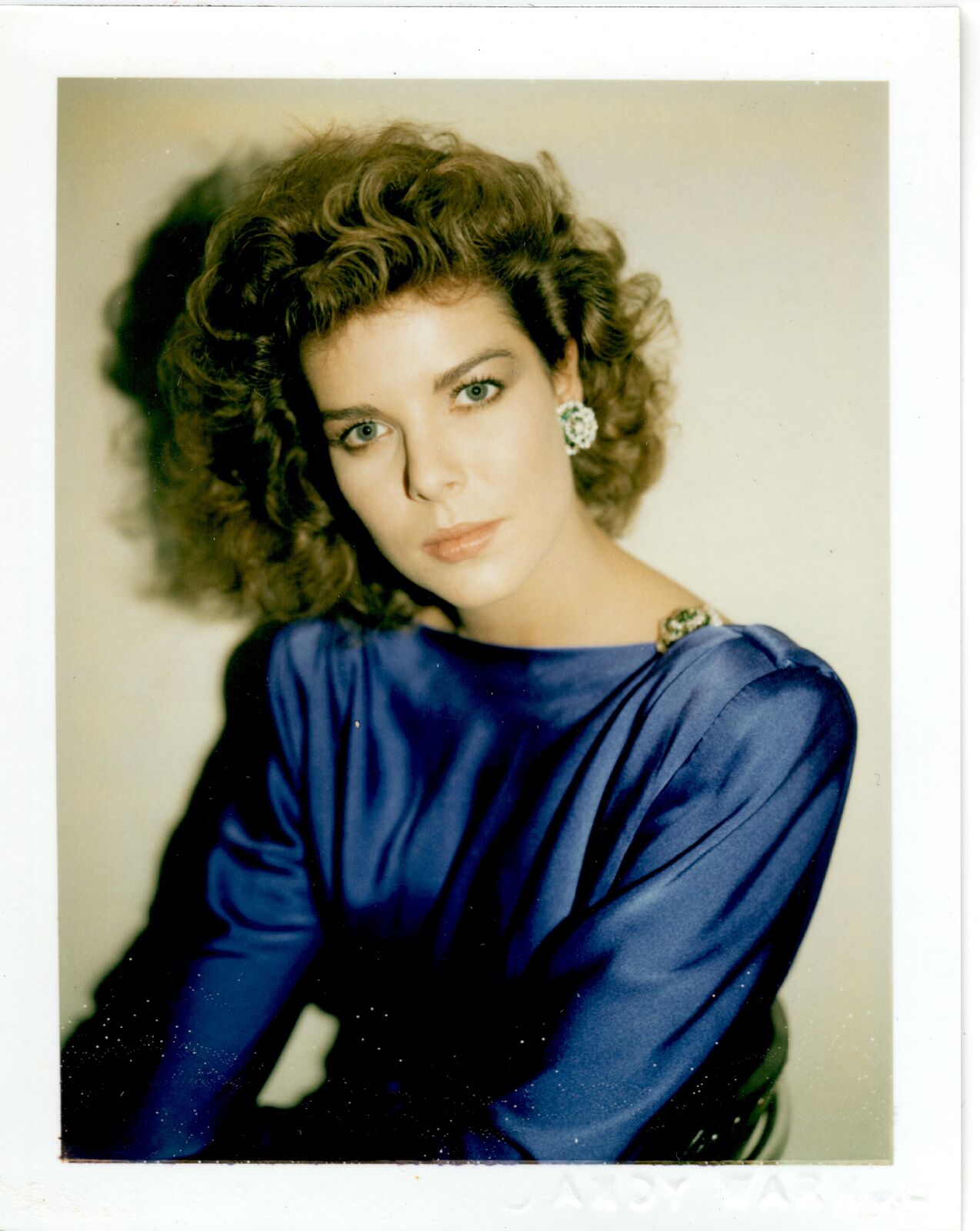 A woman in a blue dress posing for a picture.