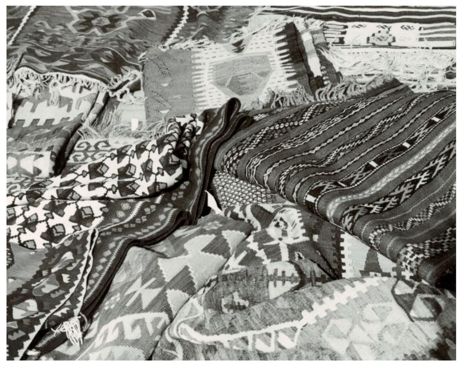 A black and white photo of a pile of blankets.