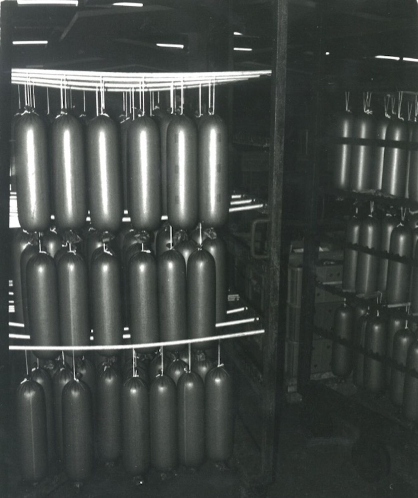 A black and white photo of a bunch of oxygen tanks.
