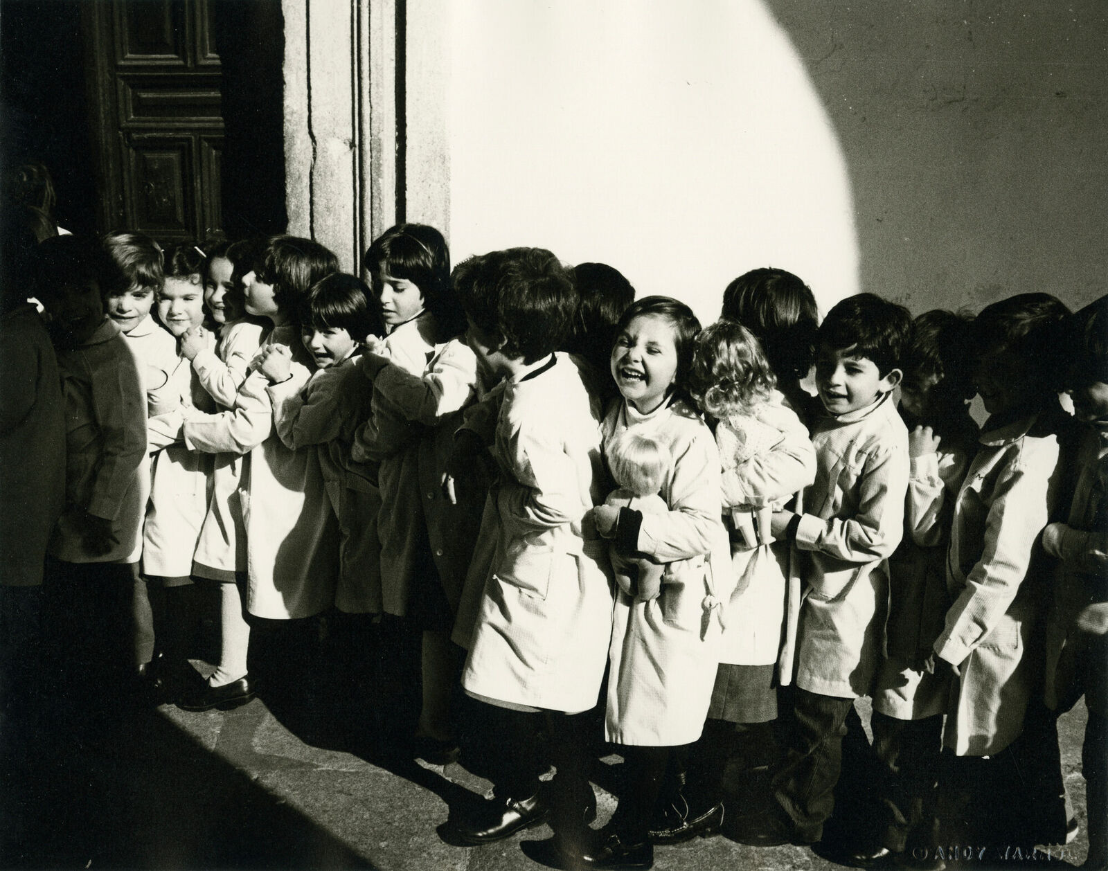 A group of children standing in front of a building.