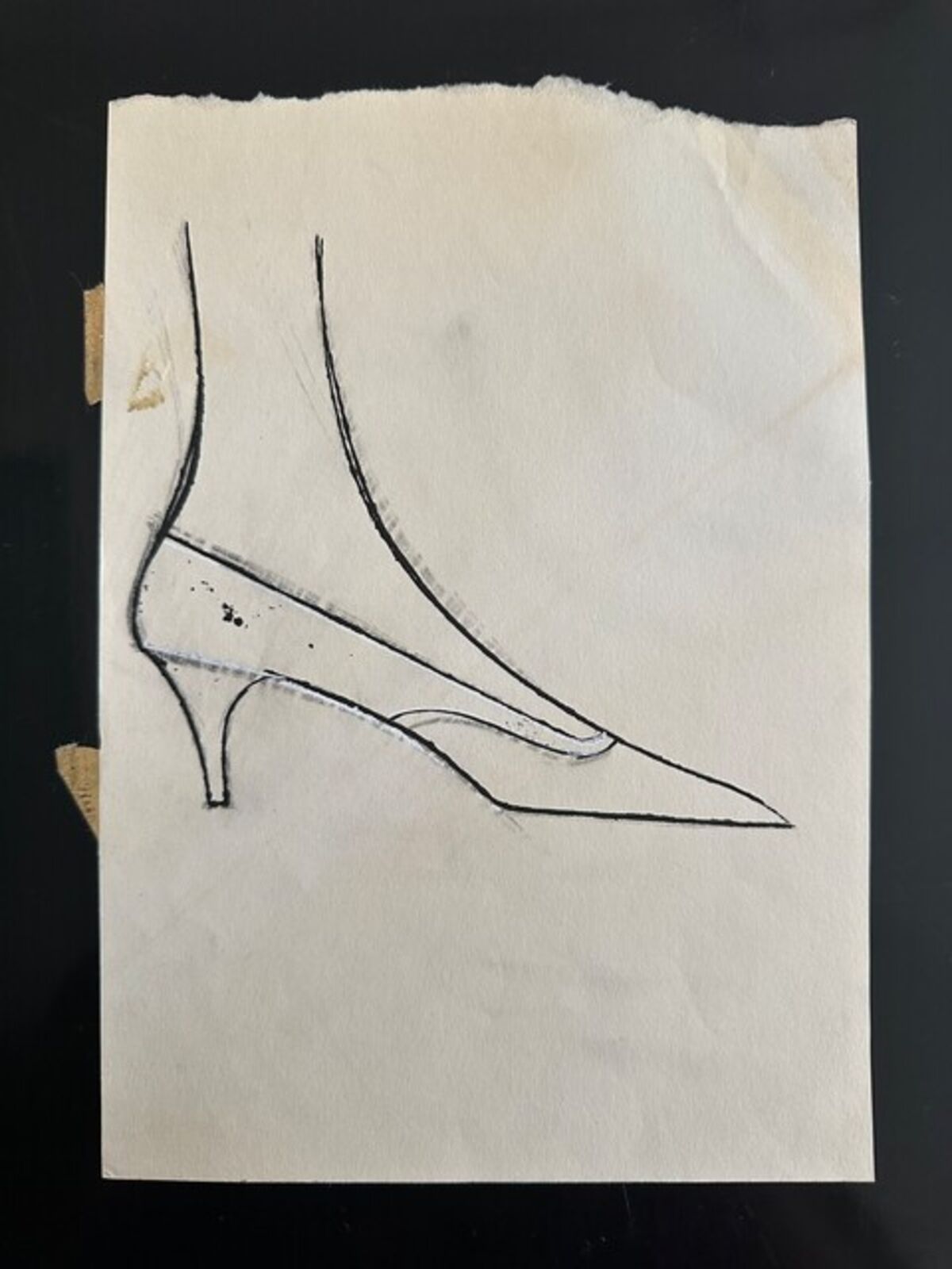 A drawing of a pair of shoes on a piece of paper.