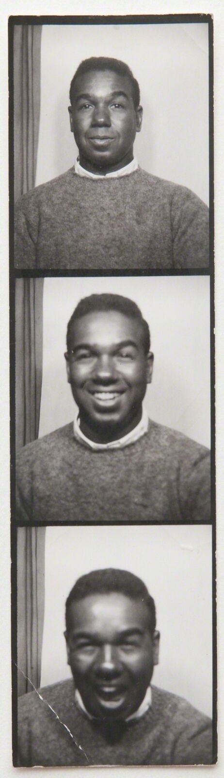a black and white photo of a man in a sweater