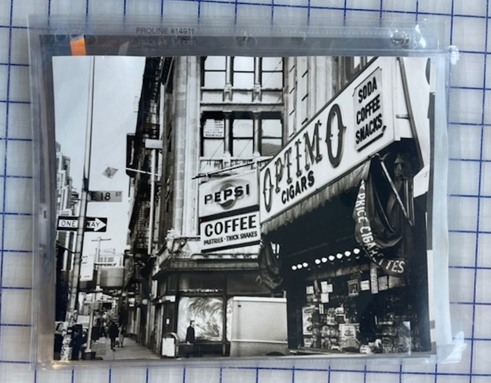 A black and white photo of a coffee shop on a city street.