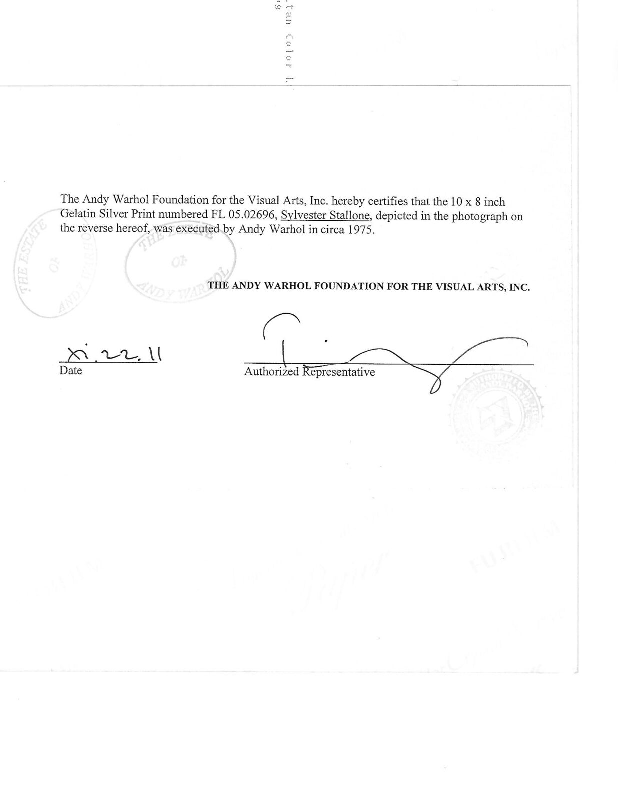 A shirtless man standing in front of a mirror.