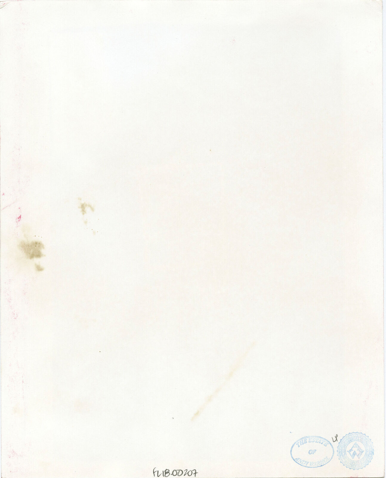 A black and white photo of a woman sitting at a table.