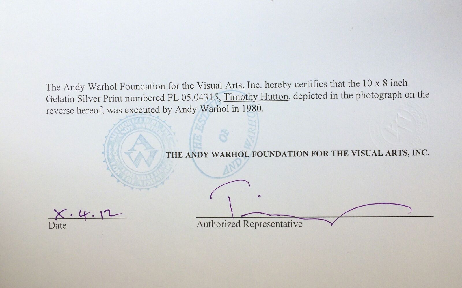 A black and white photo of a man in a white shirt.