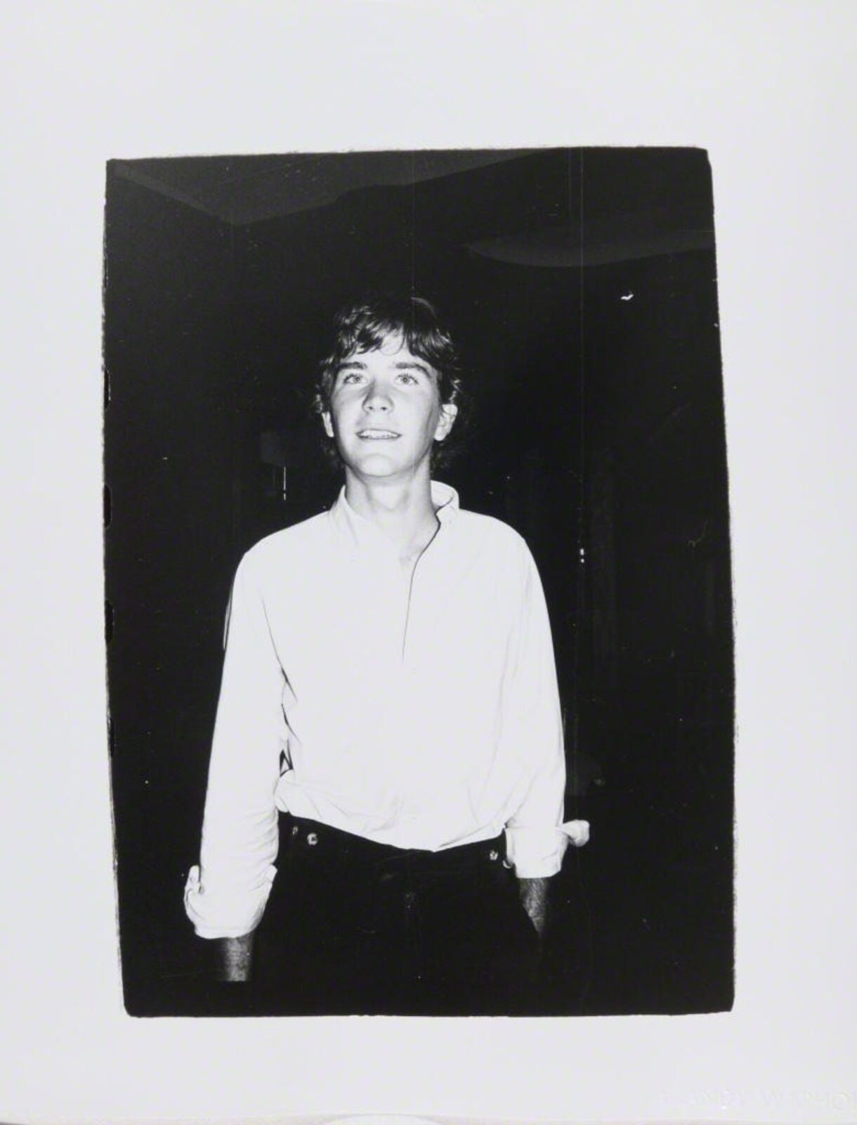 A black and white photo of a man in a white shirt.