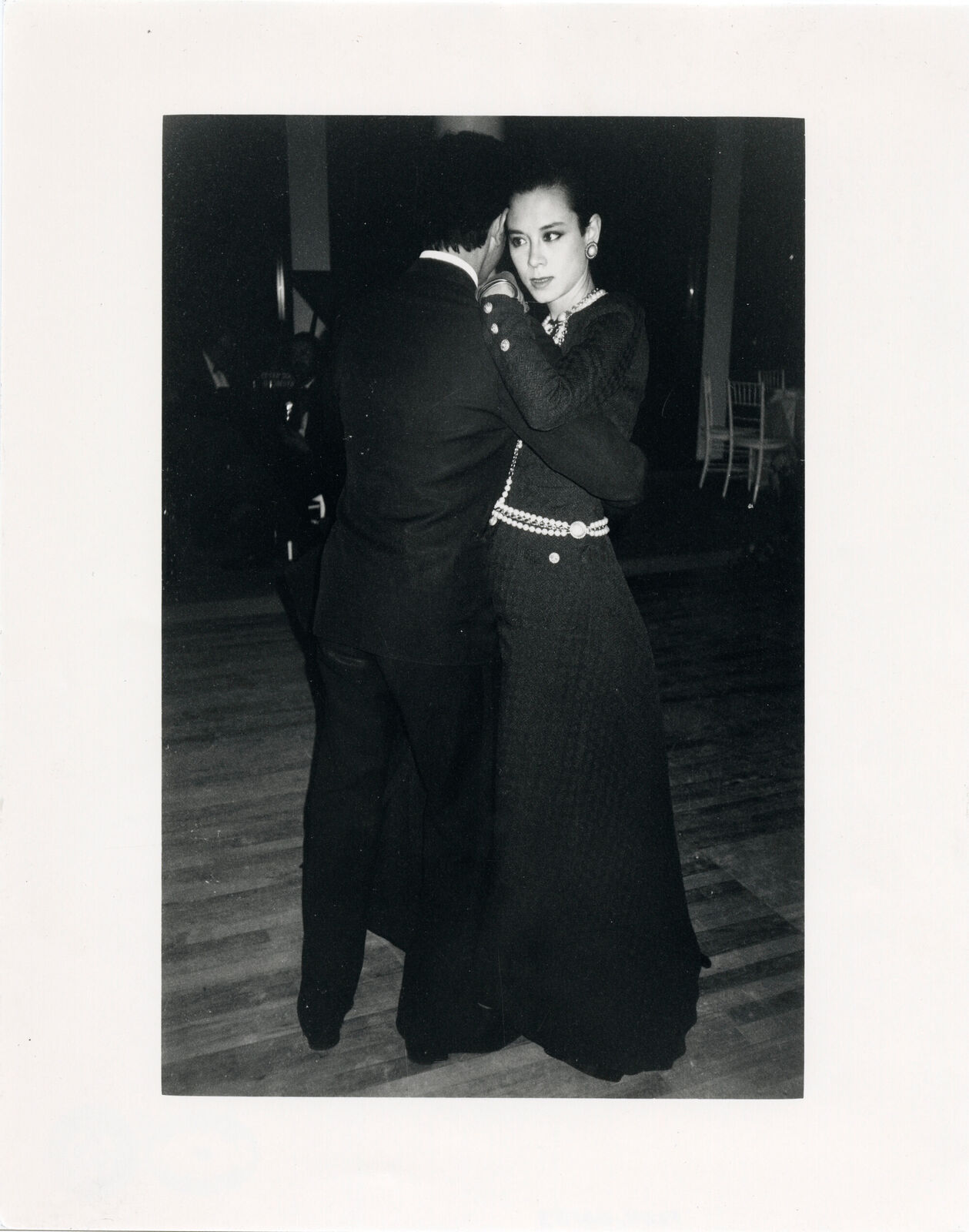 A black and white photo of a man and a woman dancing.