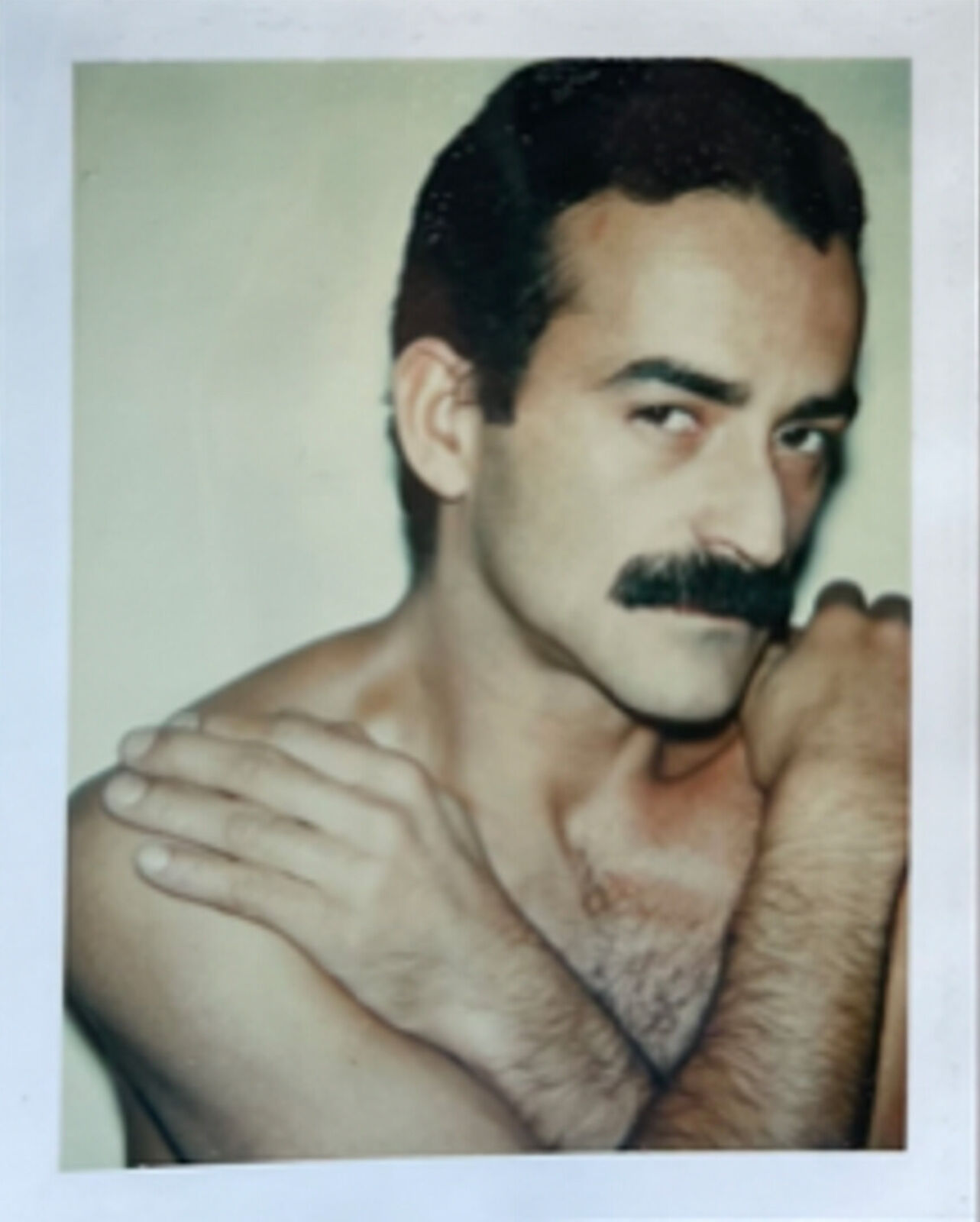 A man with a moustache on his face is posing for a picture.