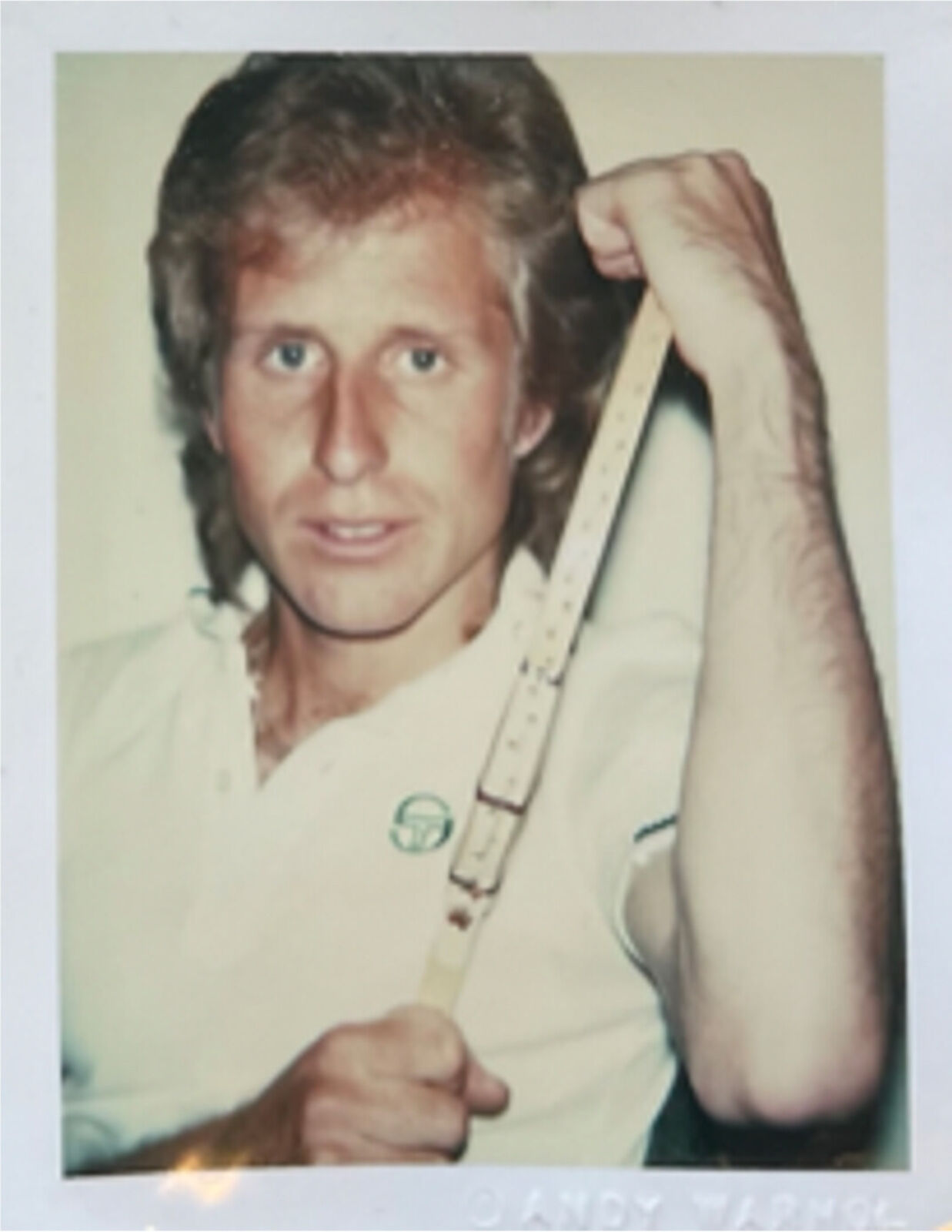 A man holding a ruler in his hand. 