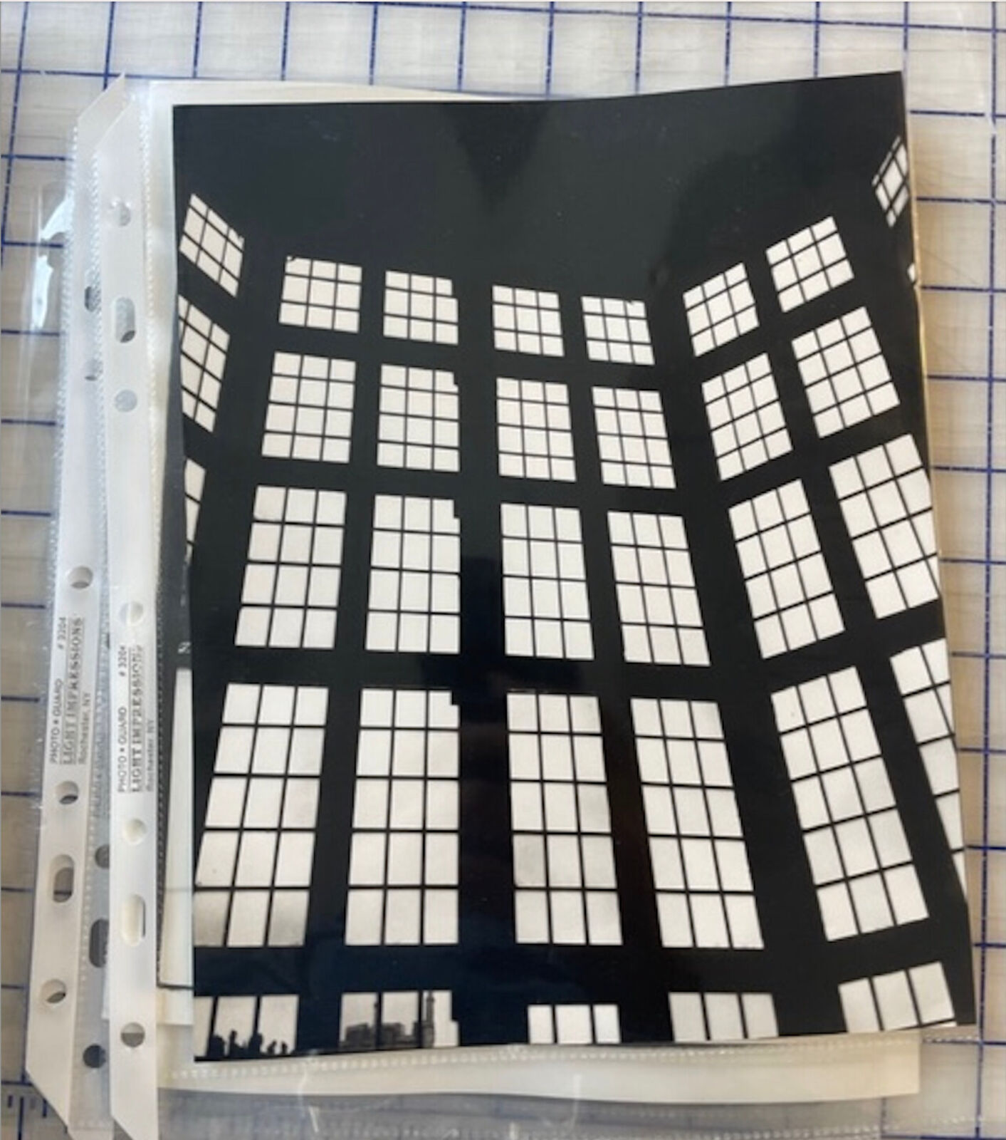 A black and white photo of a large window in a building.