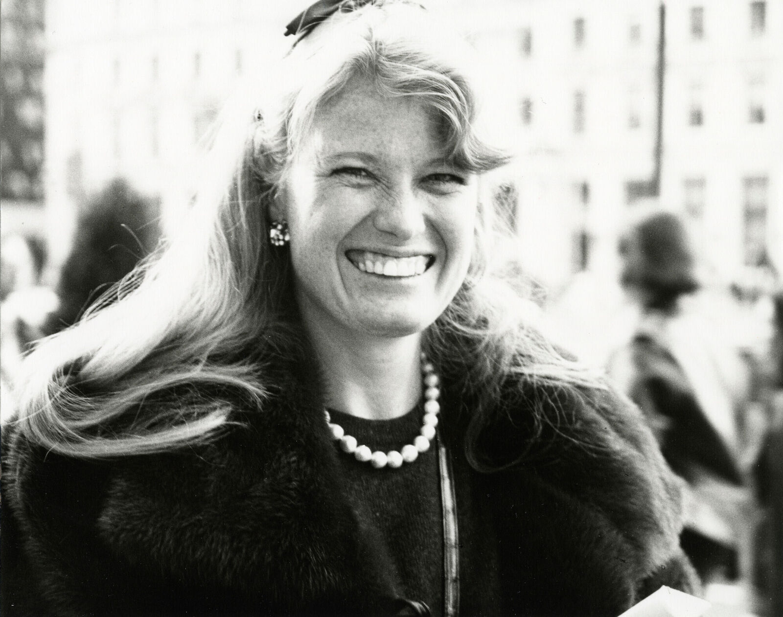 A black and white photo of a woman in a fur coat.