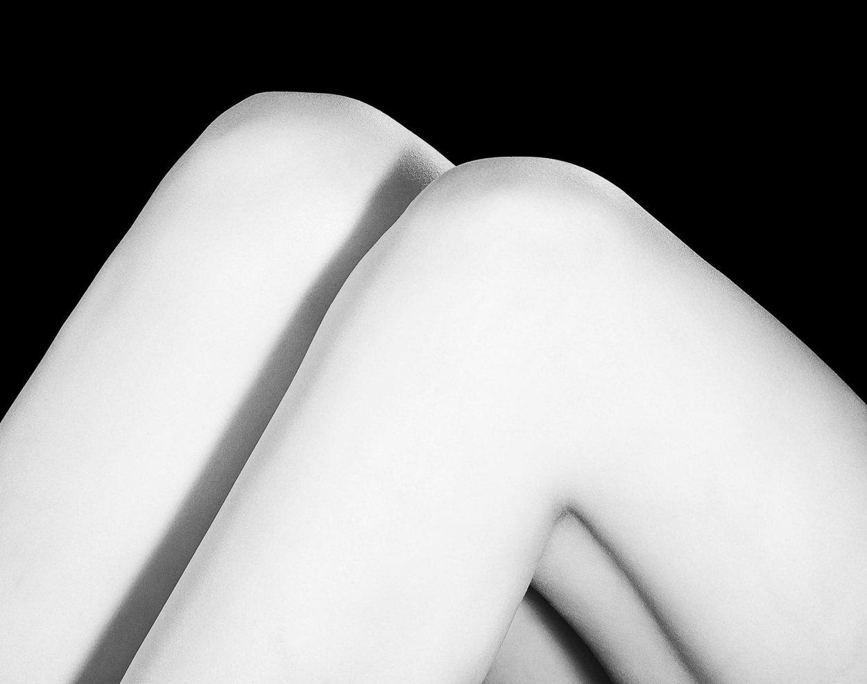 A black and white photo of a woman's legs.