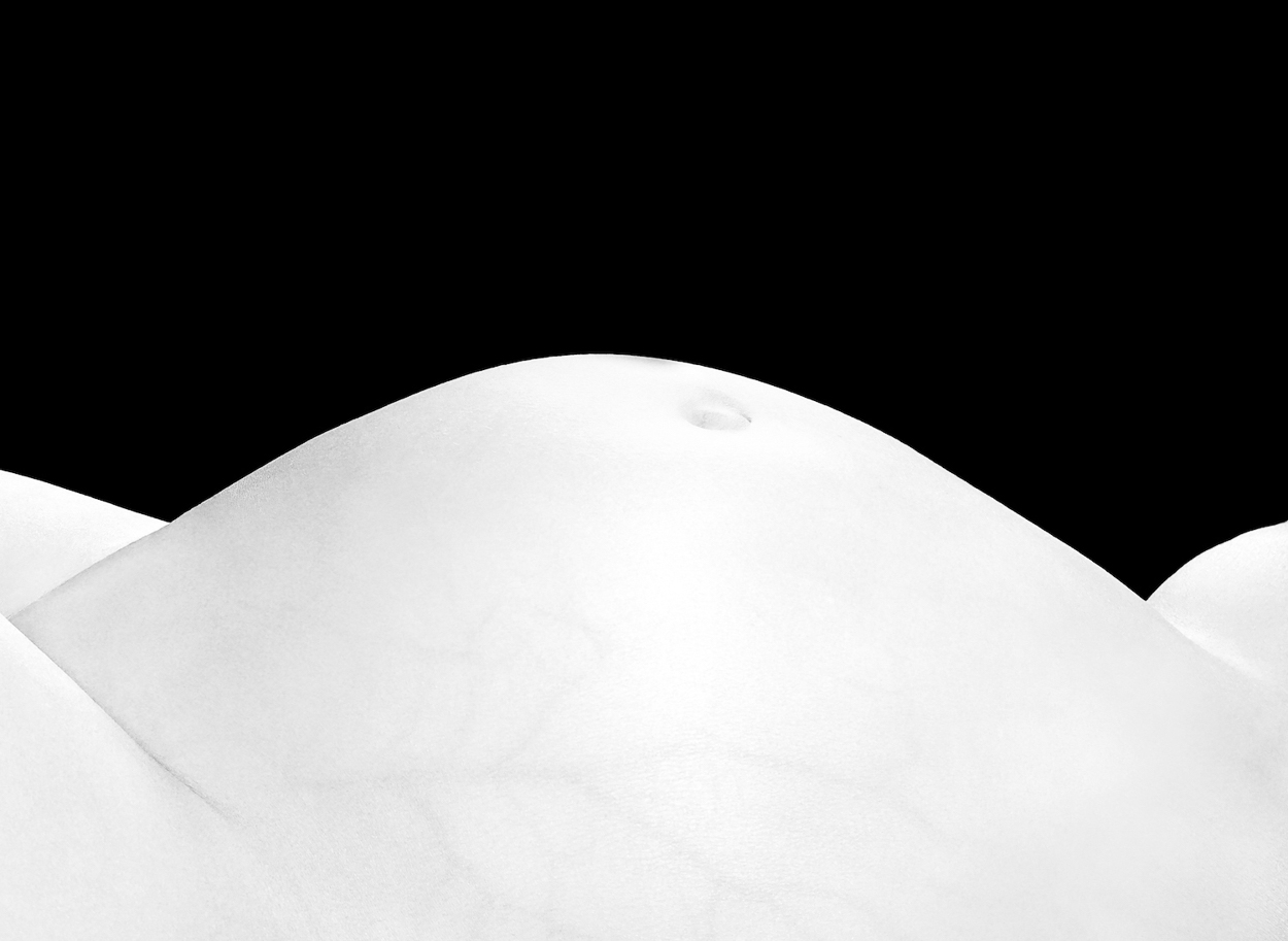 A black and white photo of a woman's breasts.