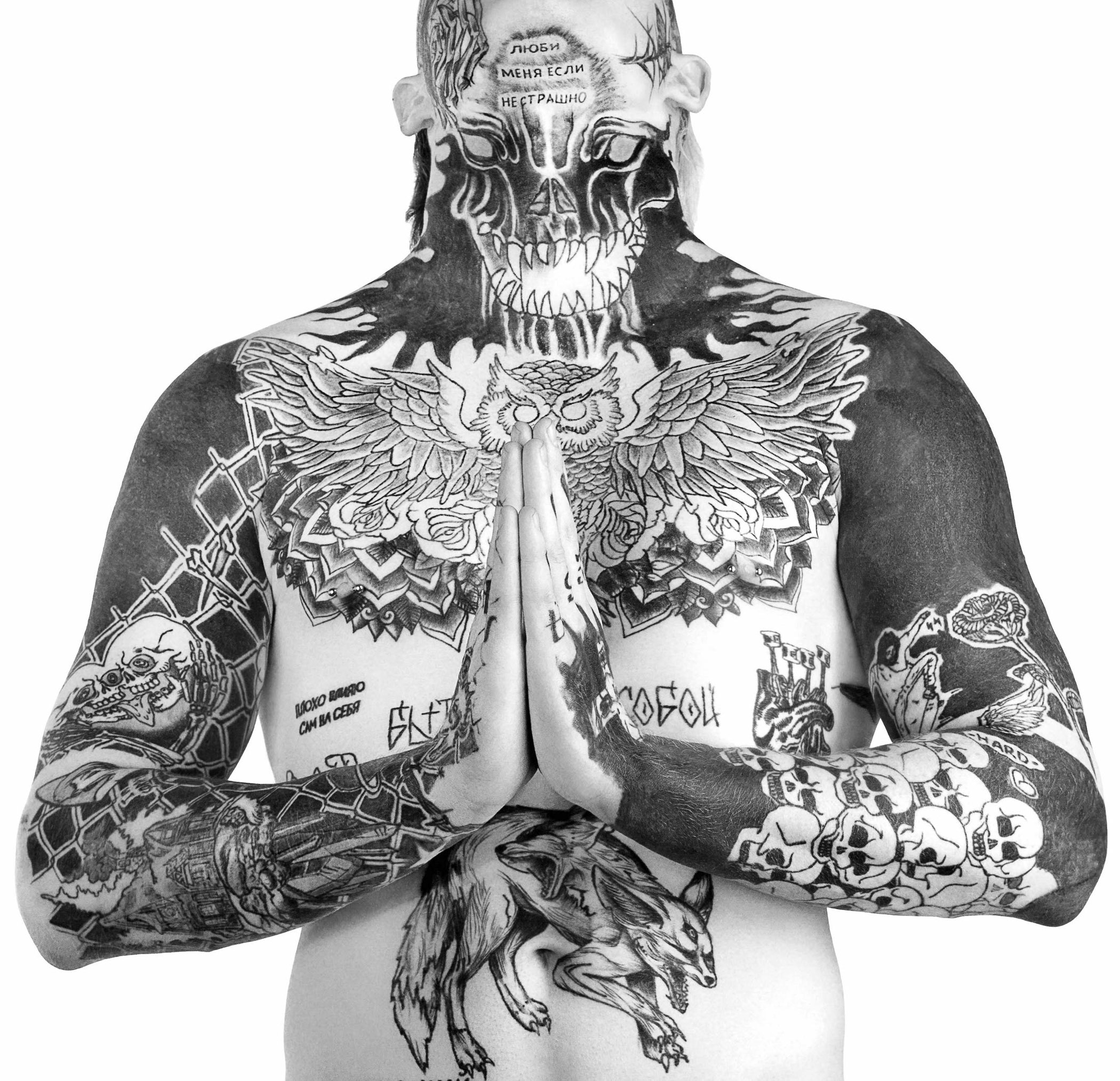 A man with tattoos on his back and arms.