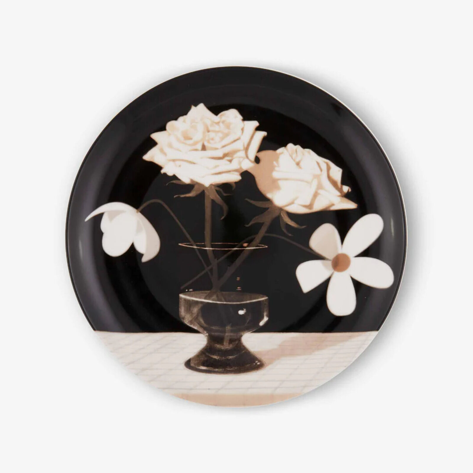 a black and white plate with flowers in a vase