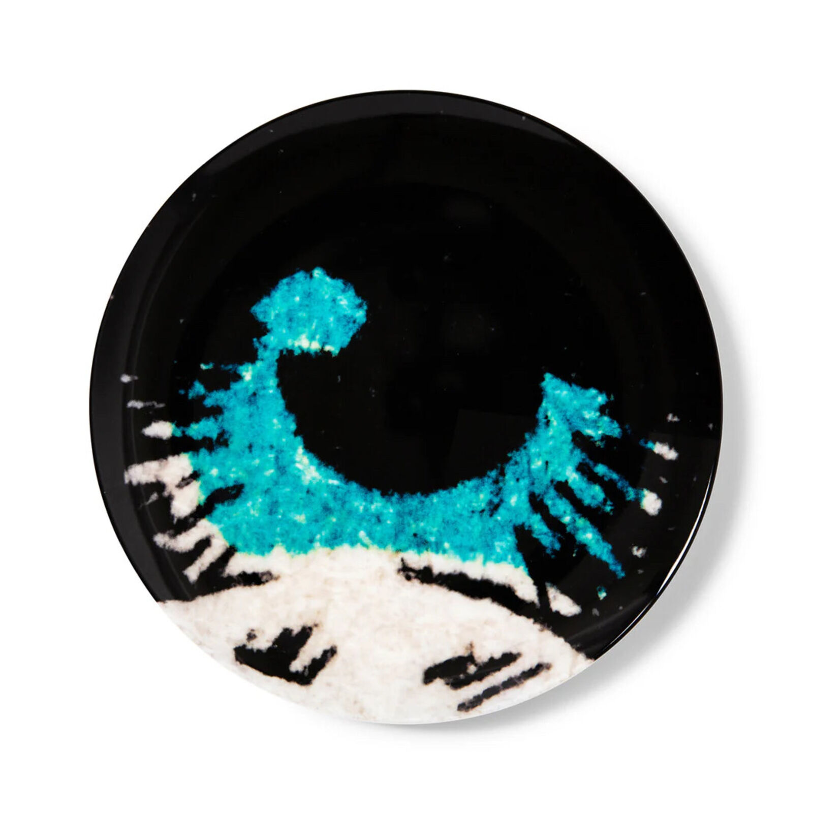 A black plate with a blue and white design on it.