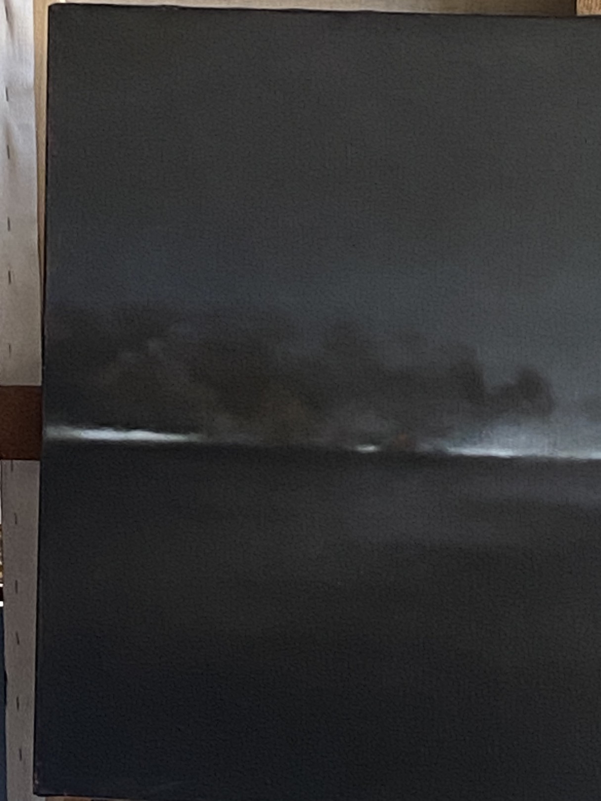 A painting of a dark sky over a body of water.