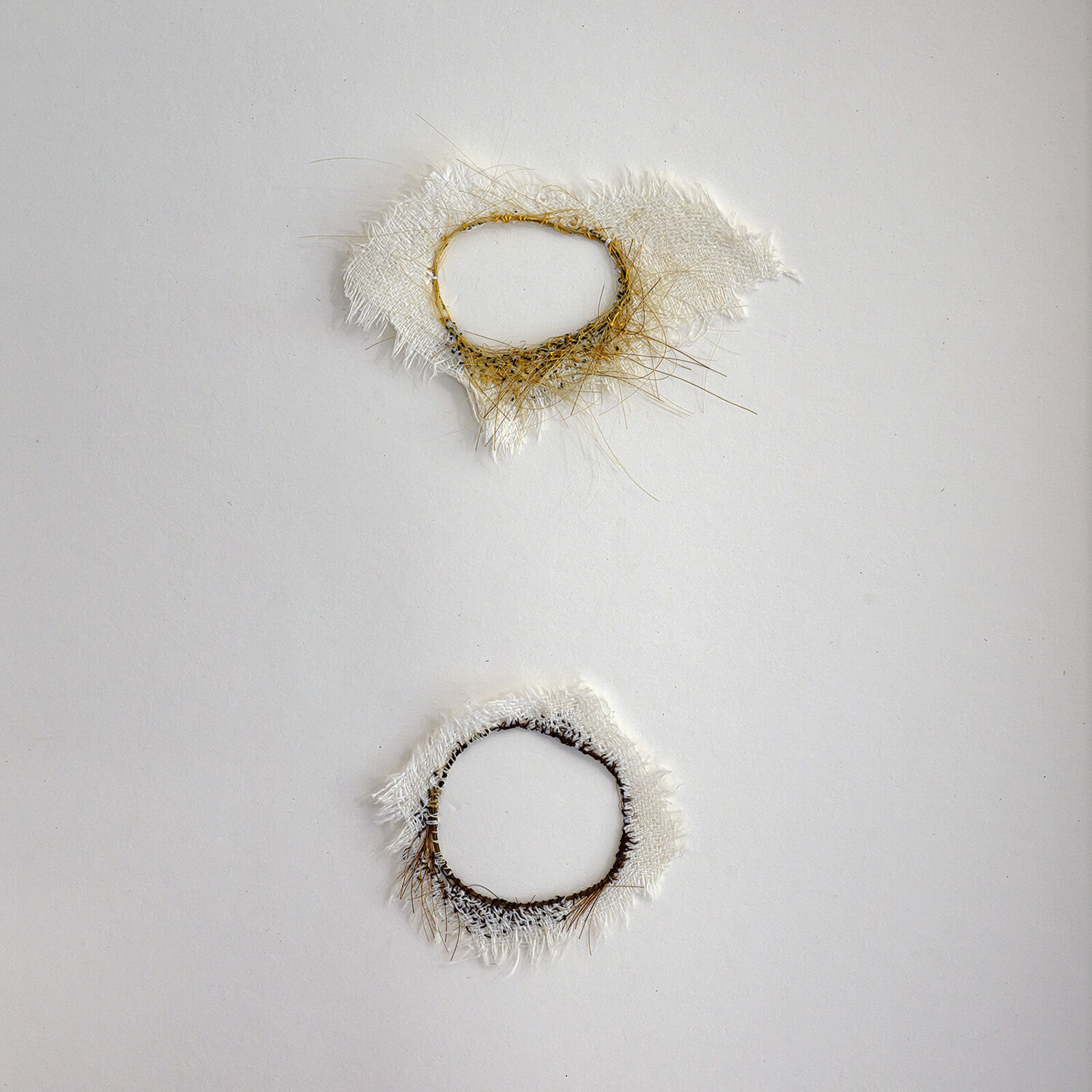 A picture of two circles in a black frame on a shelf.