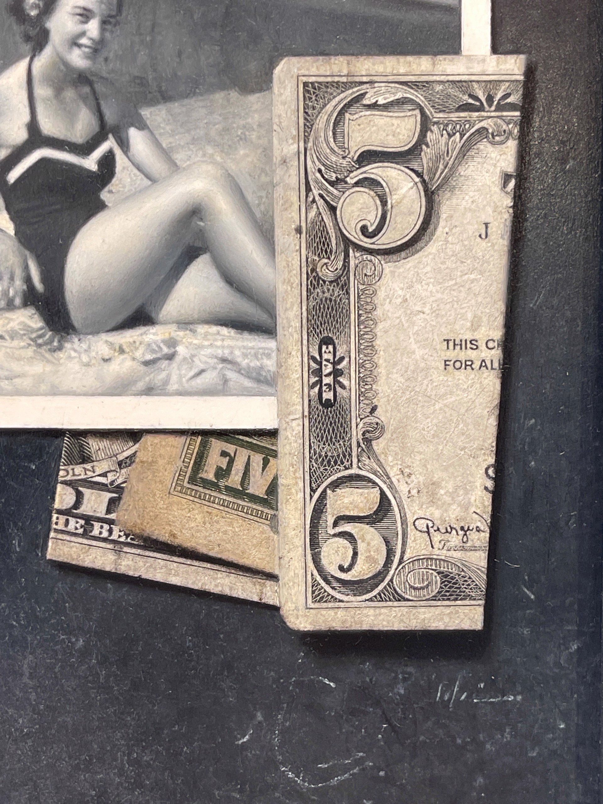 A black-and-white photograph of a figure in a swimsuit sitting on a textured surface, surrounded by vintage playing cards and currency notes.