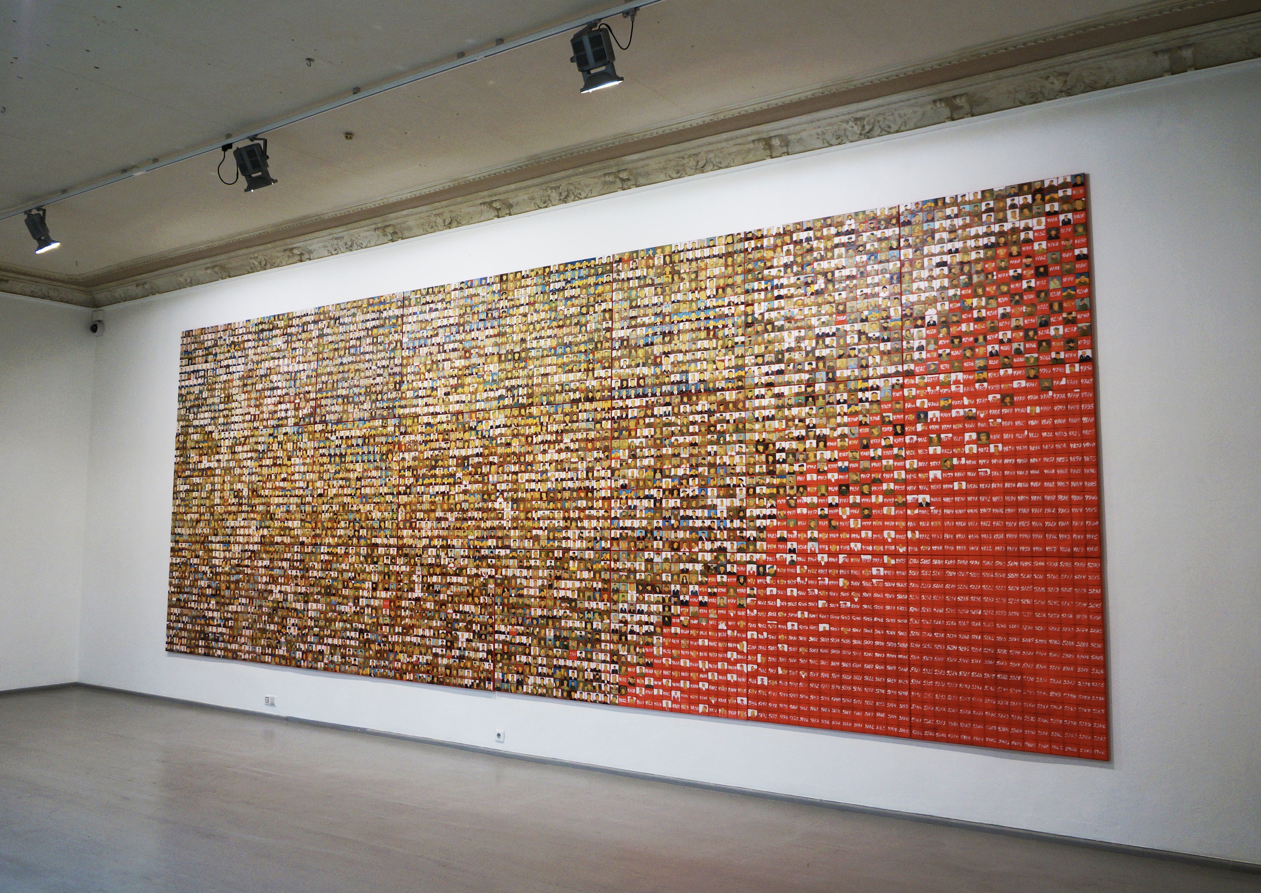 A large group of people are arranged in a mosaic pattern.