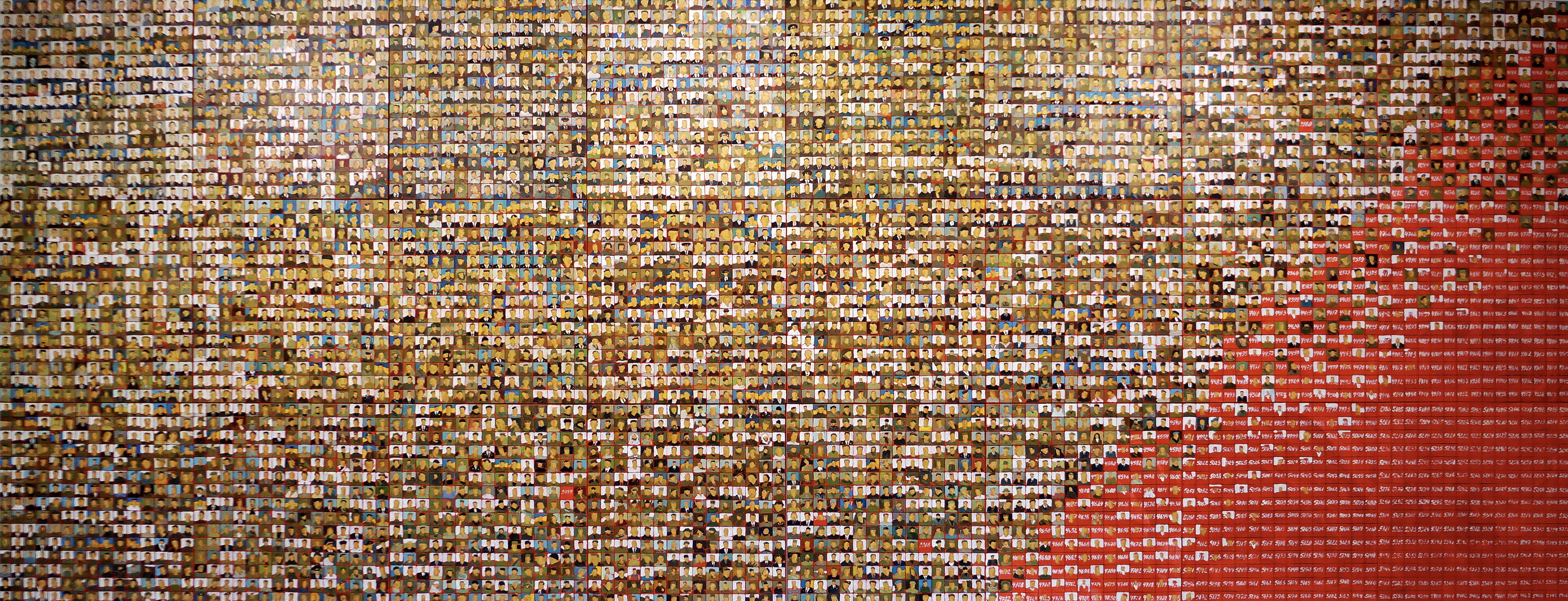 A large group of people are arranged in a mosaic pattern.