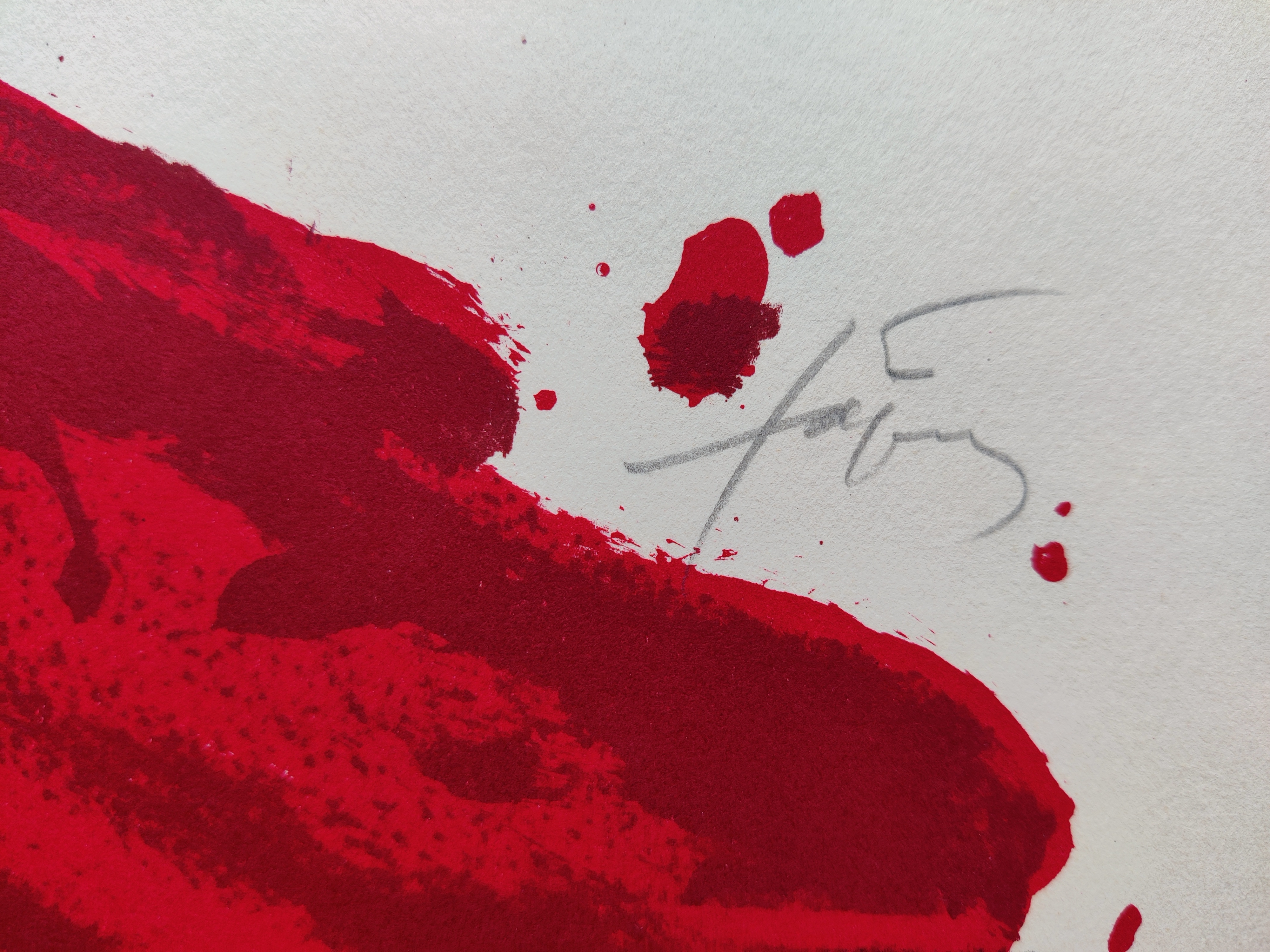 A graphic composition featuring a bold red cross over a plain background with scattered black marks.