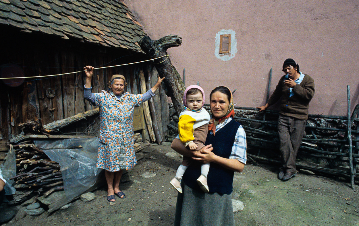 A group of people standing in front of a house.