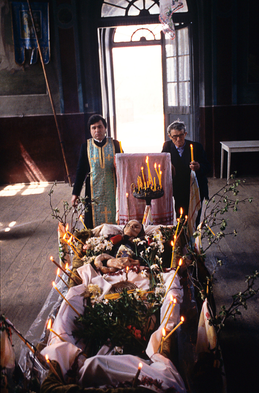 A couple of people standing next to a table with candles.