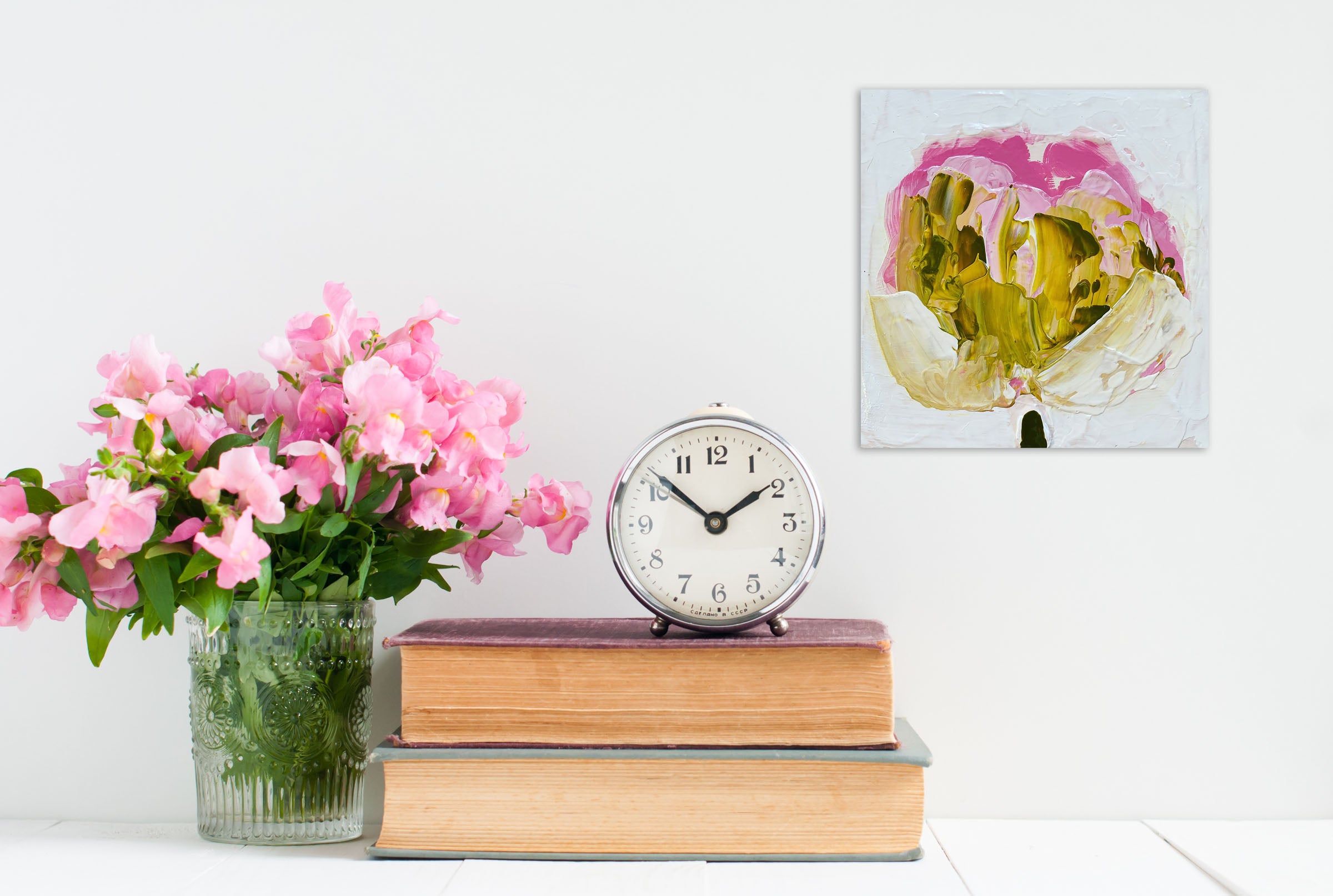 A painting of a pink and yellow flower on a white background.