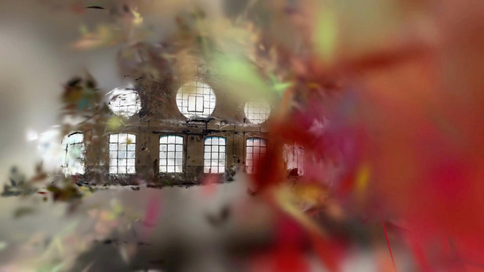 A view through a blurred, colorful lens of an abandoned building with large windows.