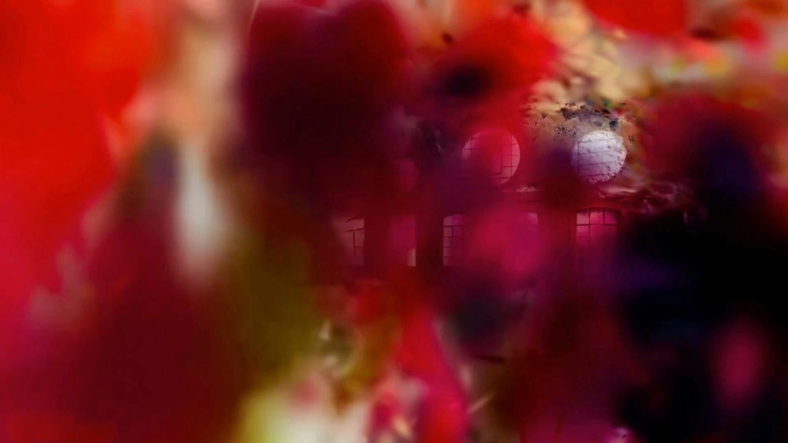 A dreamlike, abstract composition of a building seen through a vibrant, colorful blur.