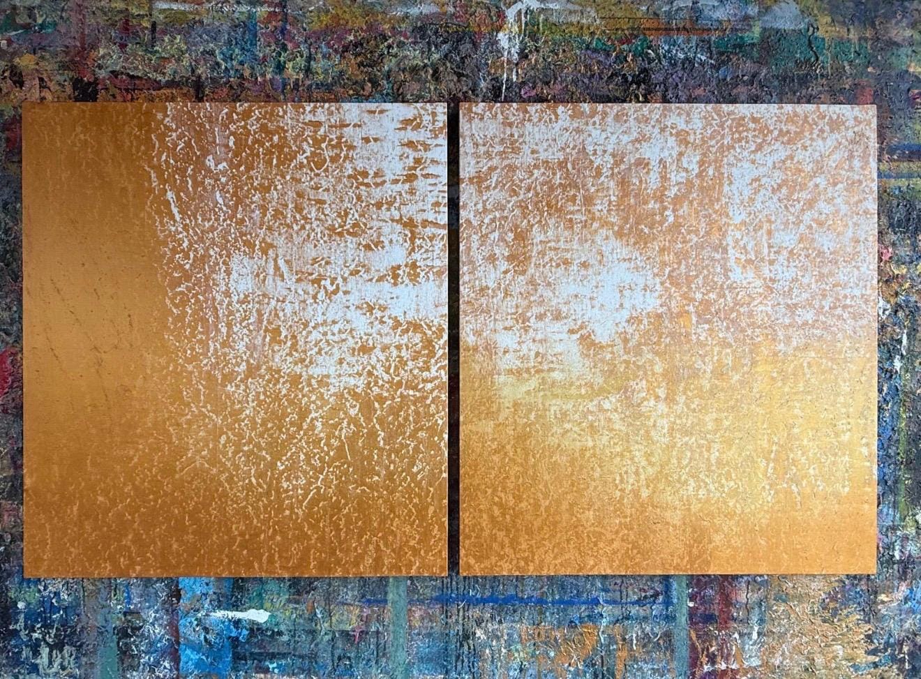 A diptych of textured gold panels resting on a colorful, abstract background.