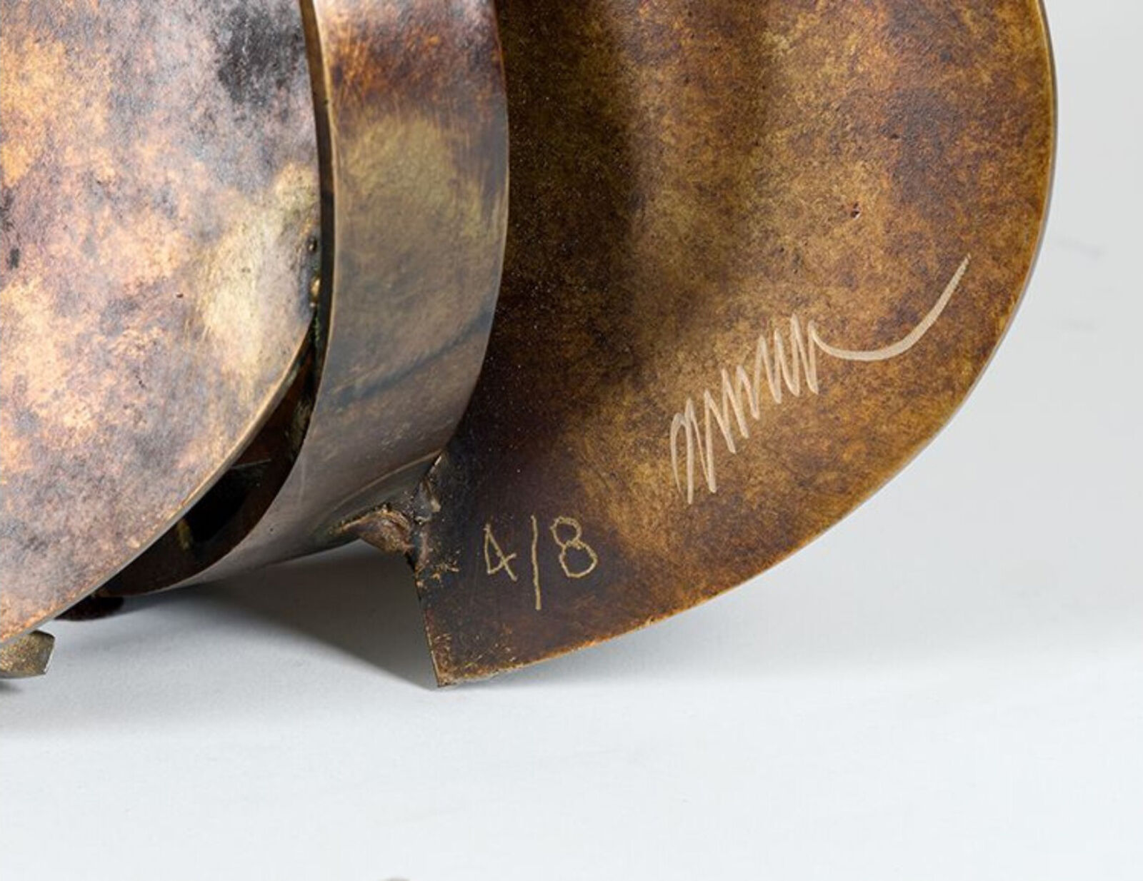 A brass sculpture of a trumpet, cello and trombone on a white background.