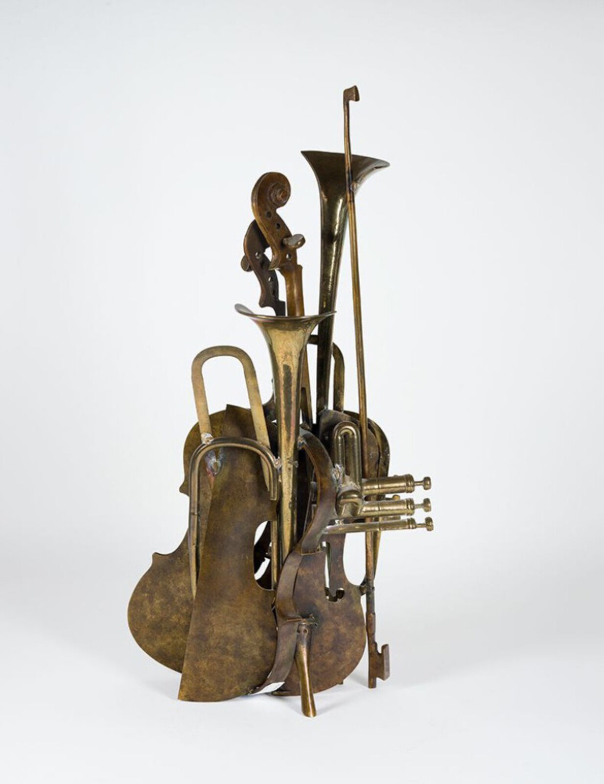 A brass sculpture of a trumpet, cello and trombone on a white background.