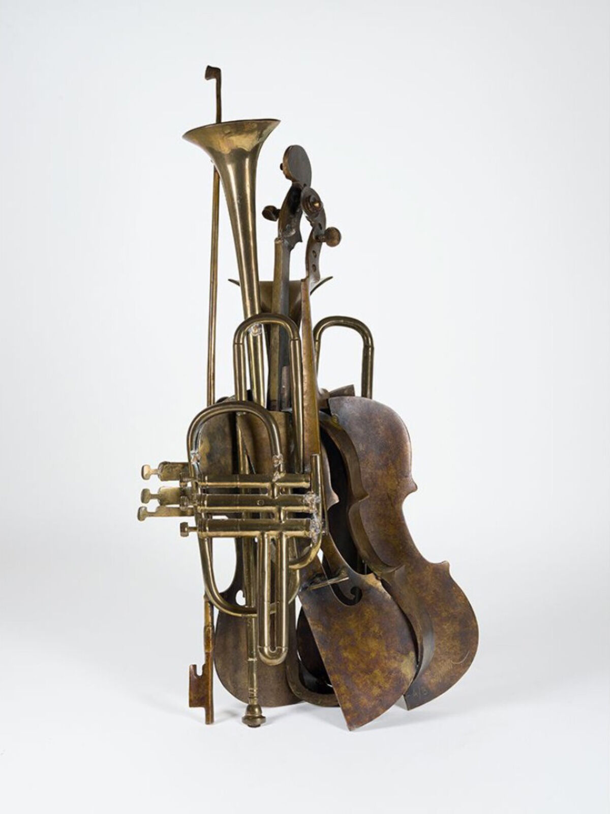 A brass sculpture of a trumpet, cello and trombone on a white background.