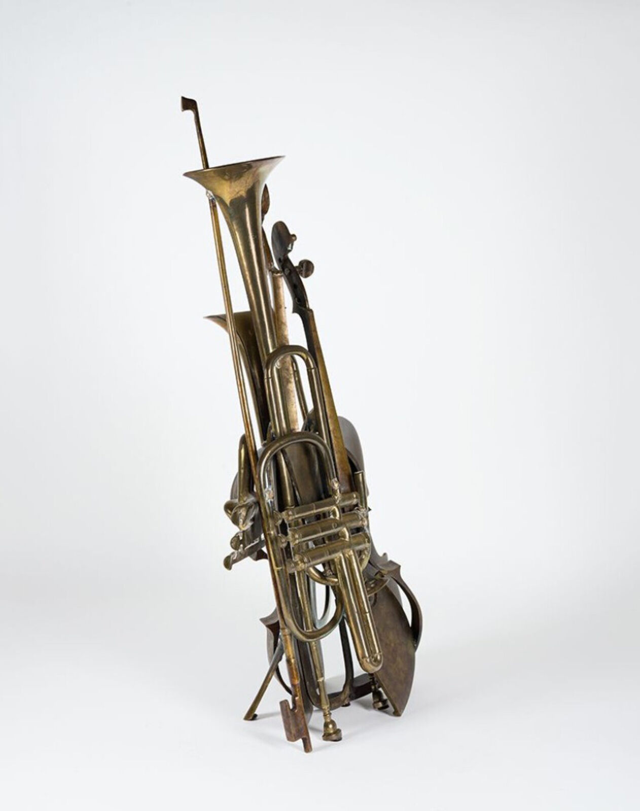 A brass sculpture of a trumpet, cello and trombone on a white background.