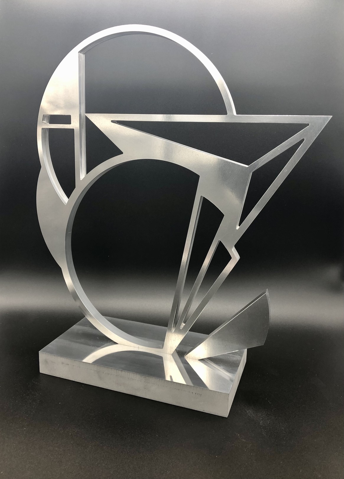 A metal sculpture on a metal base on a table.