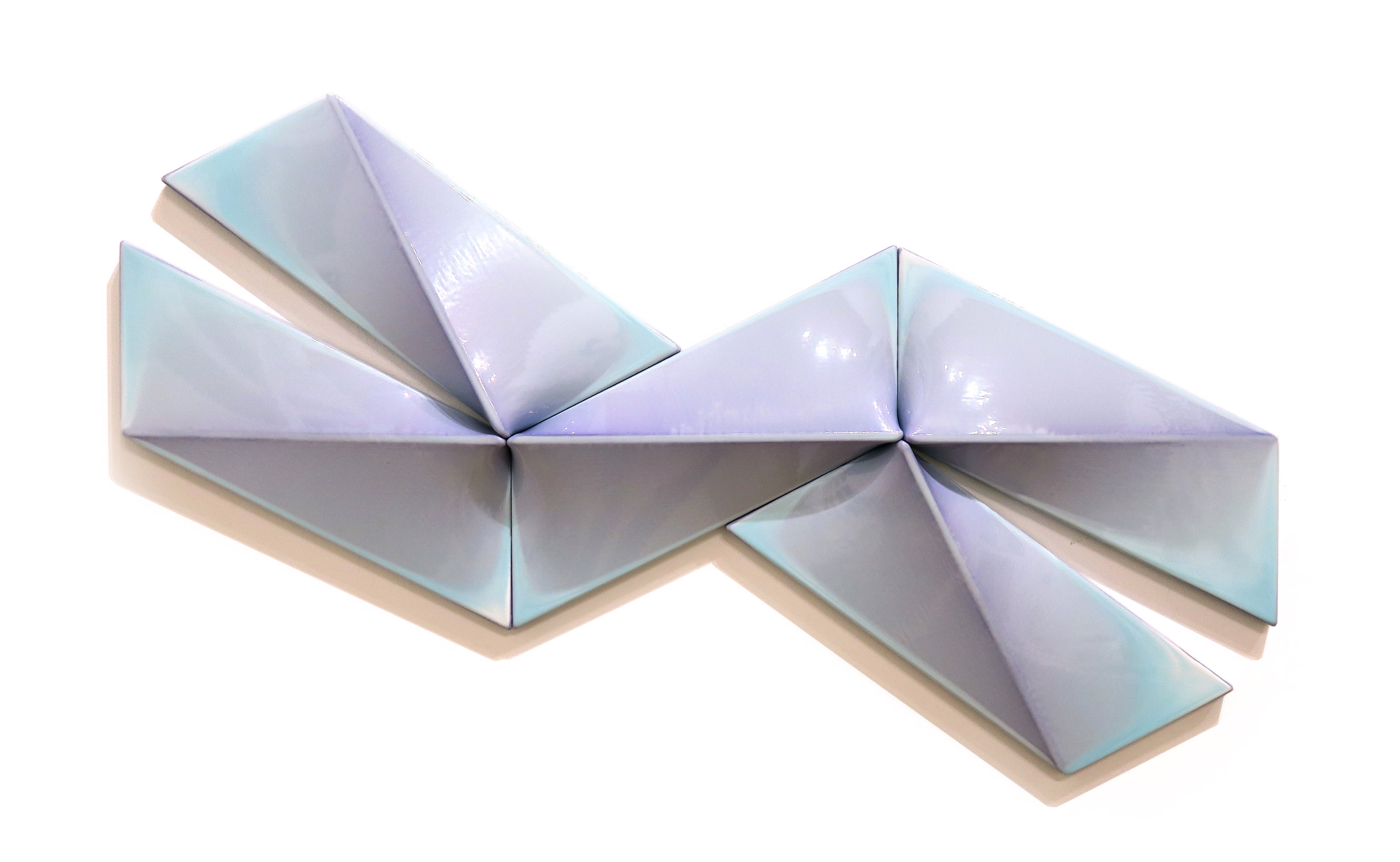 A blue and white origami piece of paper on a white surface.